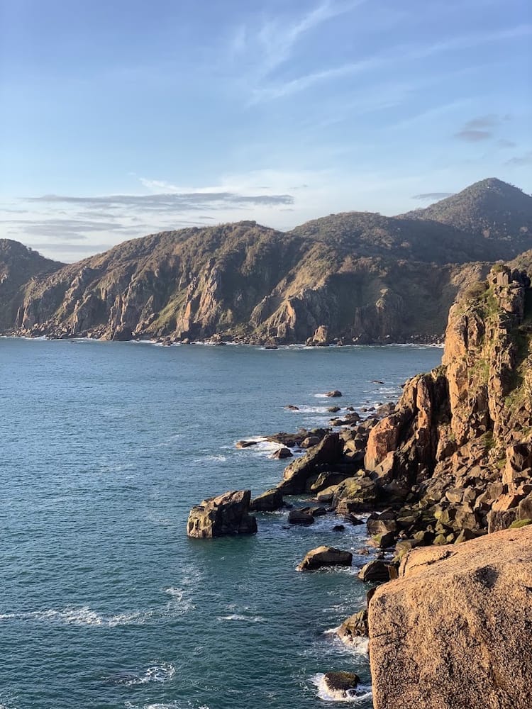 A rocky headland dropping into the sea